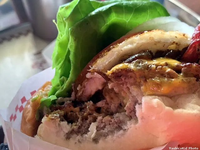 Tam-yok Burger in a pocket-shaped paper sleeve