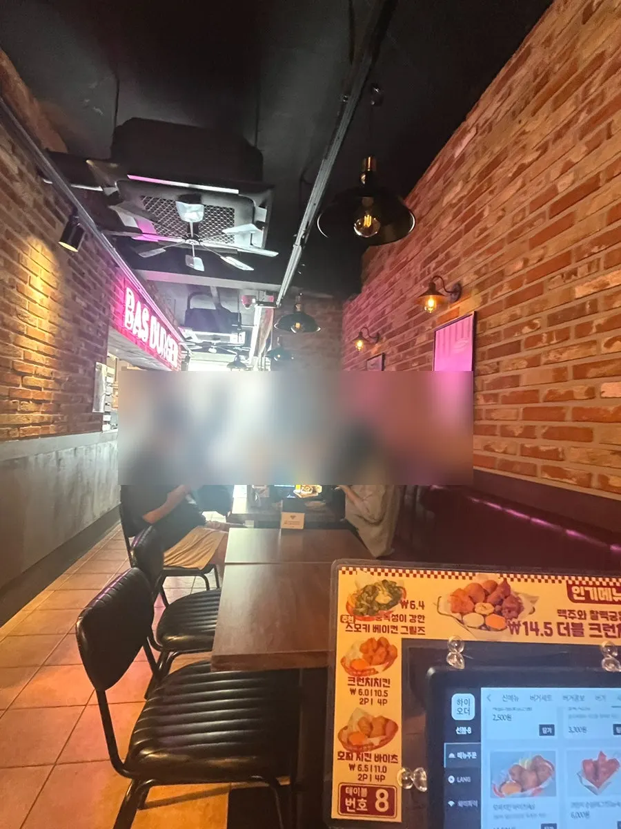 Interior of BAS Burger Seonyudo decorated with neon signs