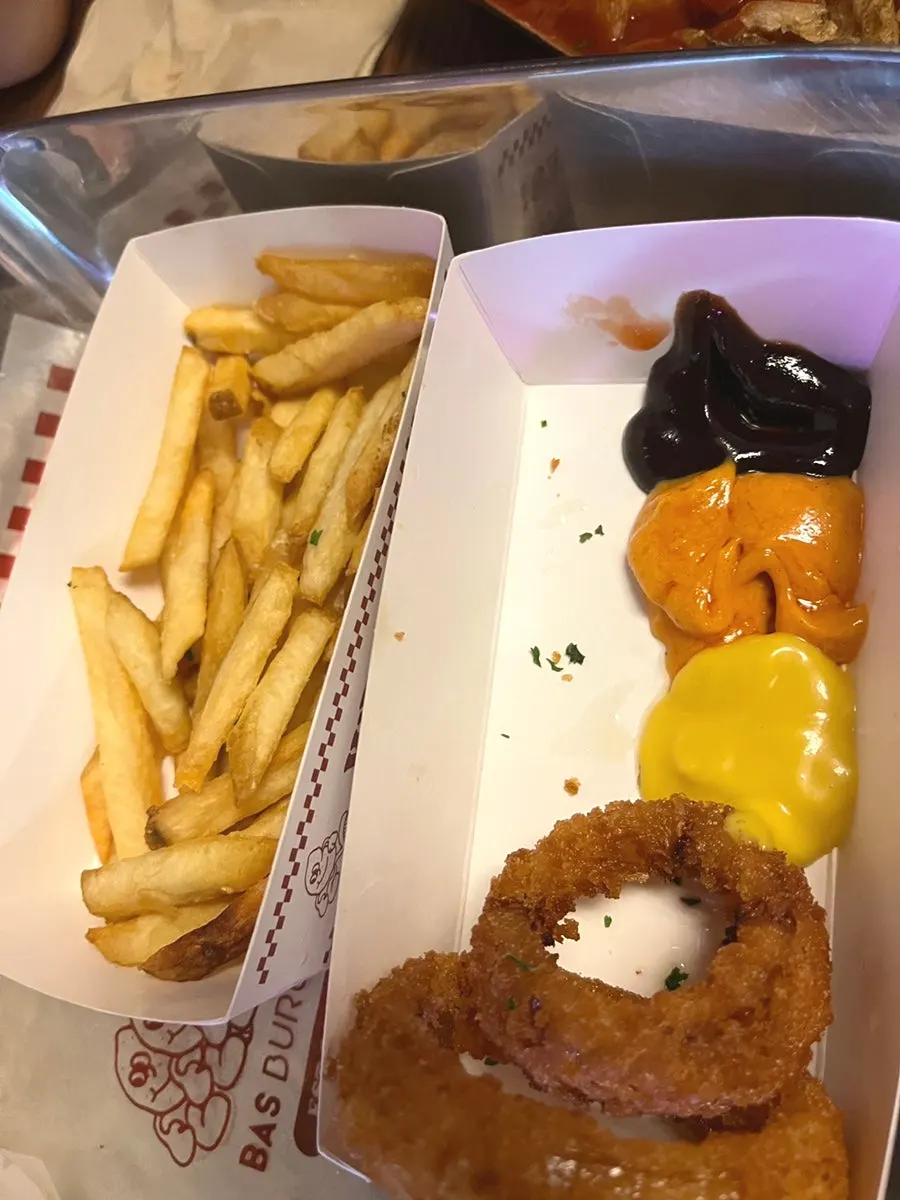 Dipping the burger and sides in sauce