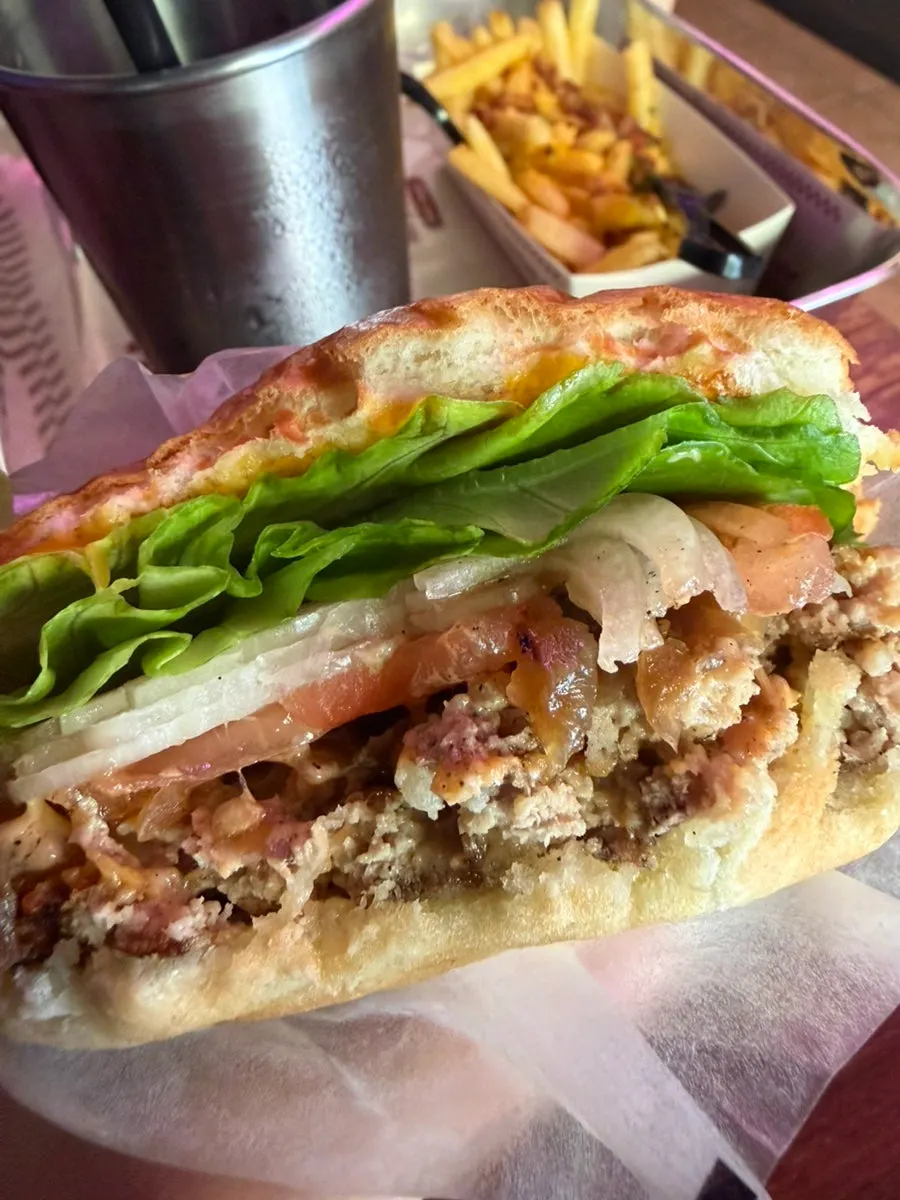 Close-up of the Double BAS Burger packed with ingredients
