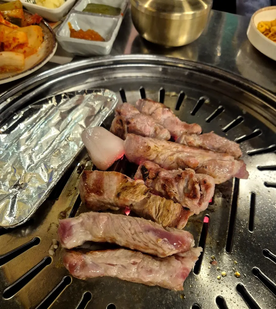 Pork neck cooking on the grill