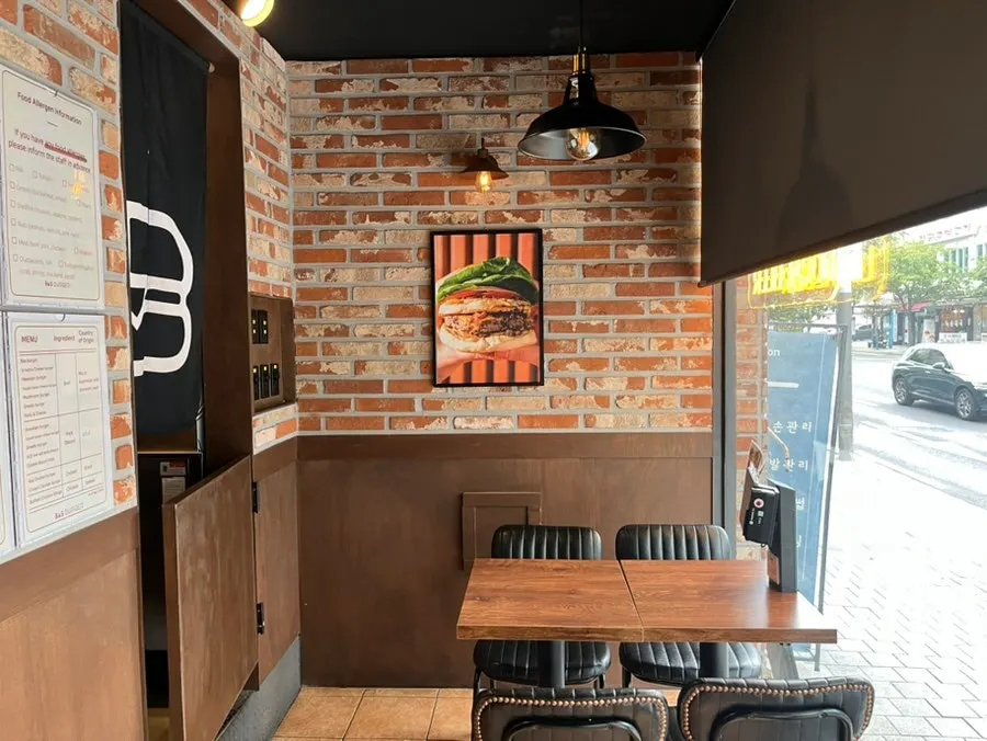 Window-side table seating at BAS Burger Seonyudo