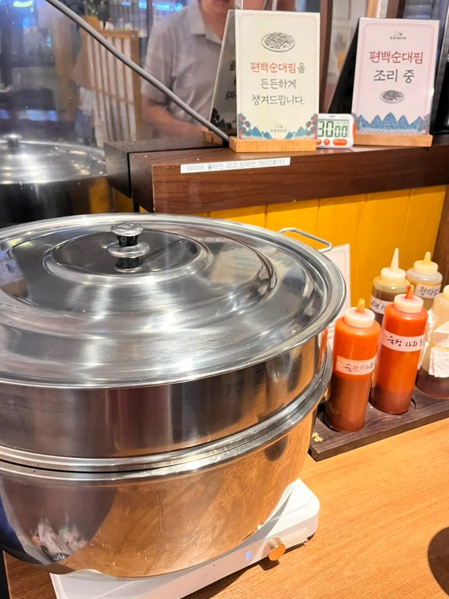 Self-serve side dish corner with cubed radish kimchi and napa kimchi