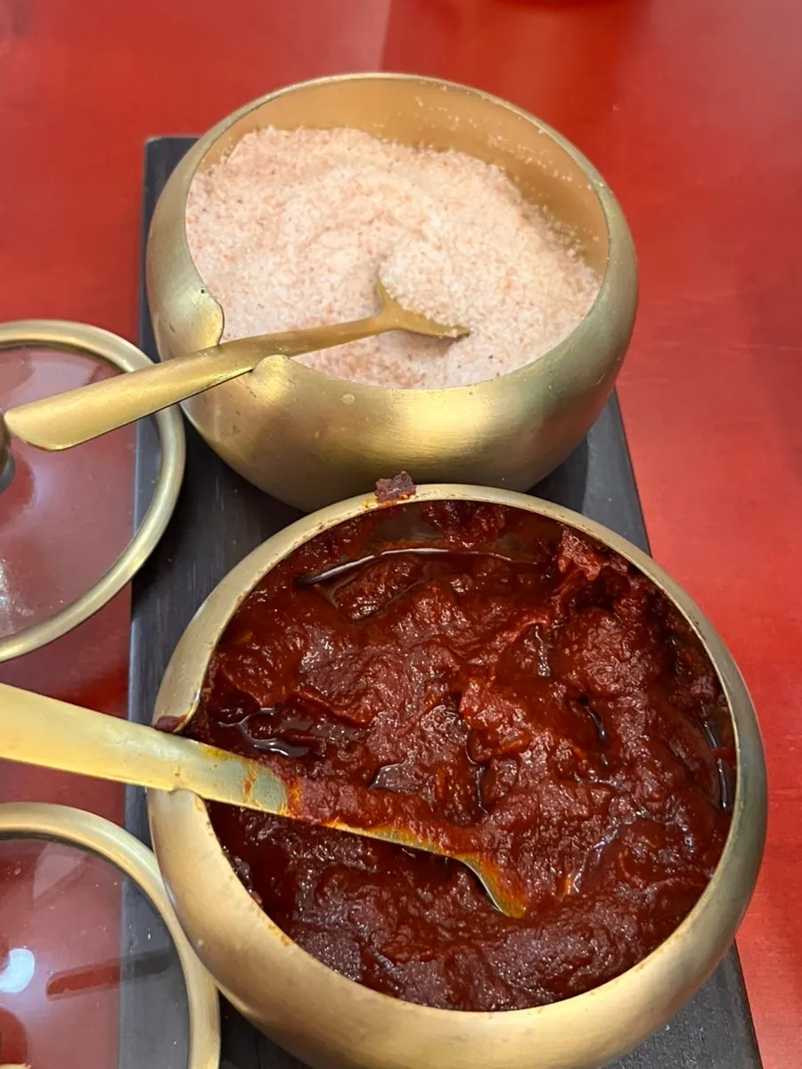 A piece of chapsundae dipped in sauce