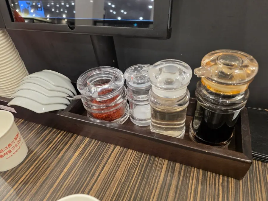 Neatly arranged individual plates and sauce containers on the table