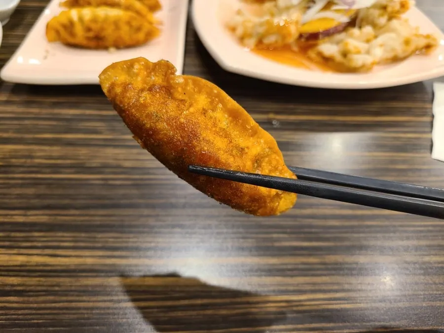 Close-up of reddish, golden-fried jjamppong mandu