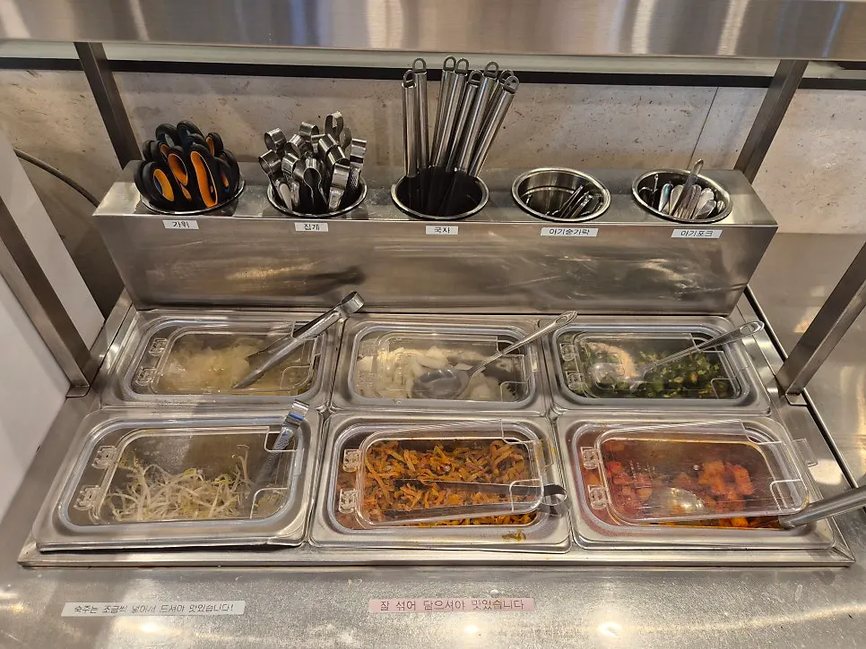 셀프바에 놓인 가위와 앞치마 등 비품