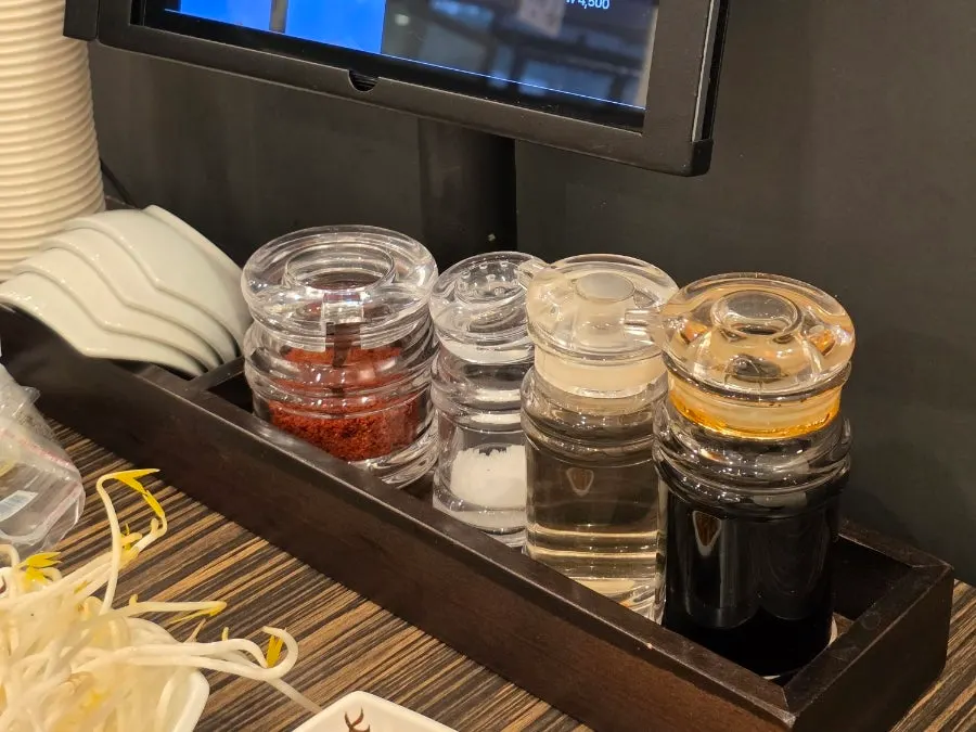 Table with plates, condiments, and kiosk