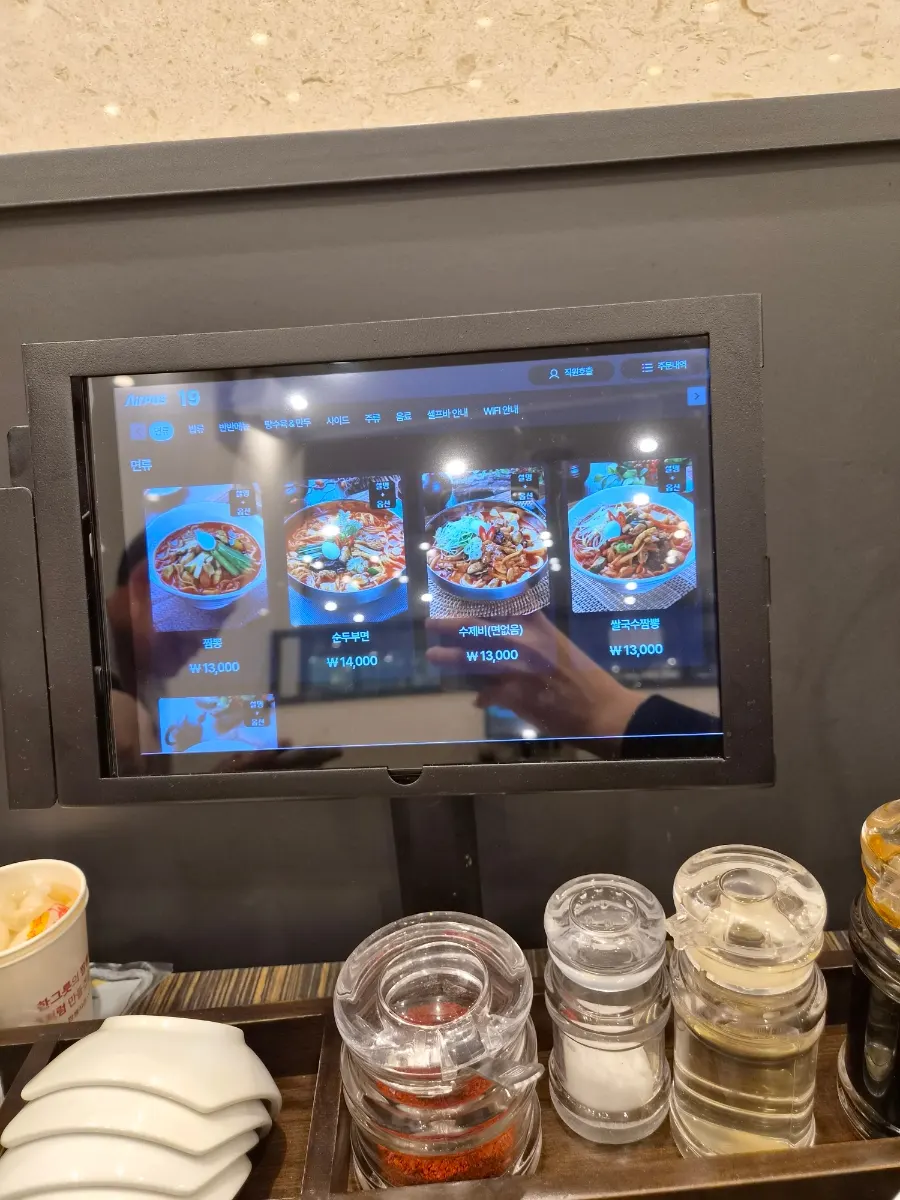 Table with kiosk ordering system at Jjamppong Jijeon