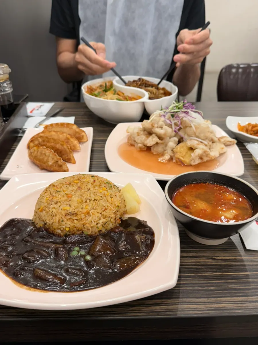 Full spread of Chinese dishes photographed before eating