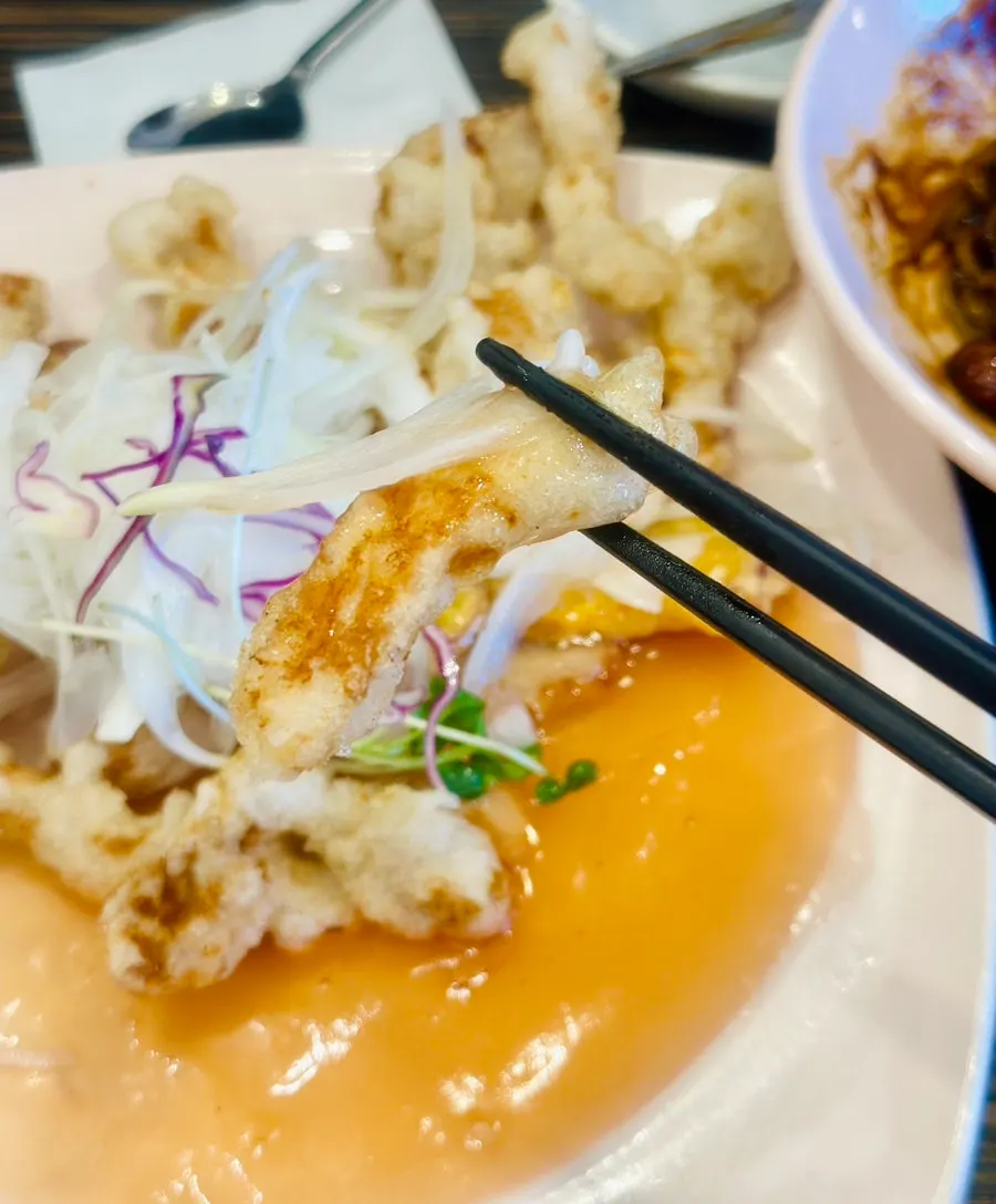 Close-up of tangsuyuk with sauce and onion