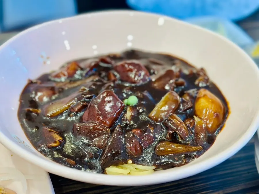 A bowl of jjajangmyeon with generous sauce