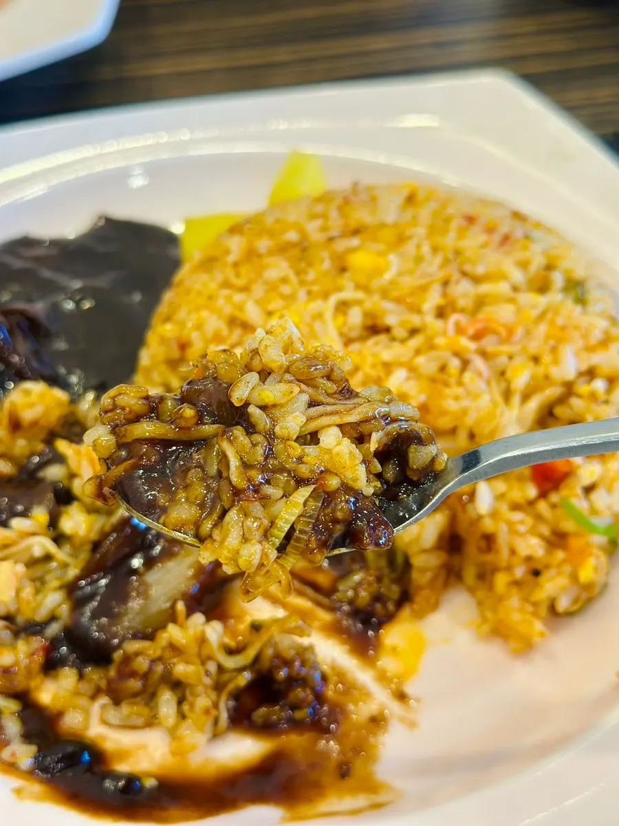 A spoonful of fried rice with crab meat