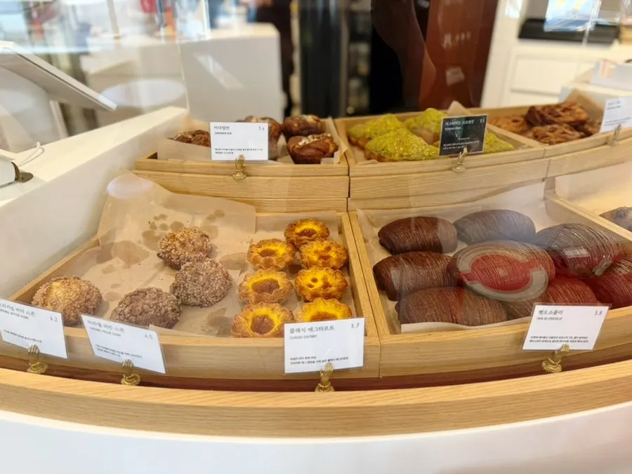 Display case with egg tarts and croissants