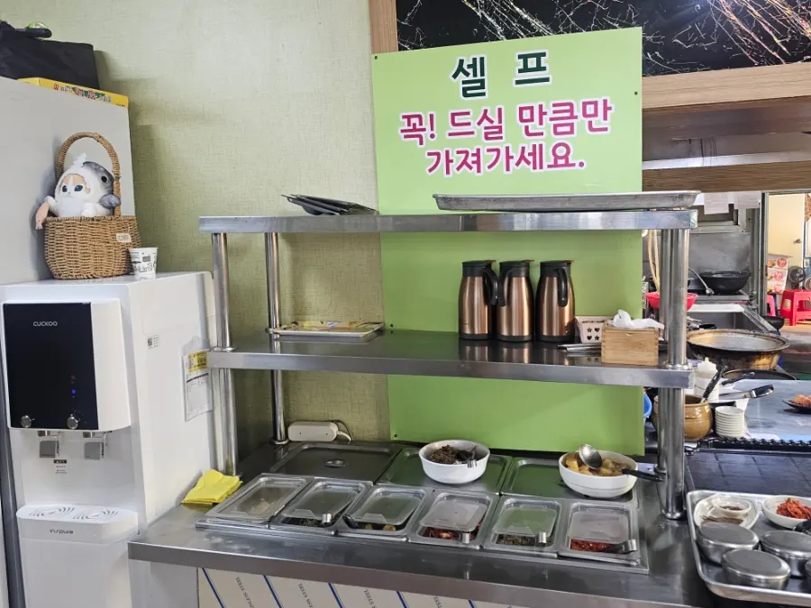 Spicy sundubu and Chodang sundubu set out with side dishes