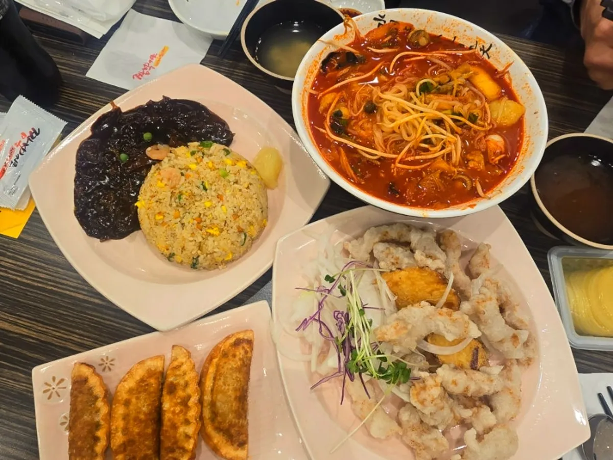 Table spread with rice noodle jjamppong and tangsuyuk