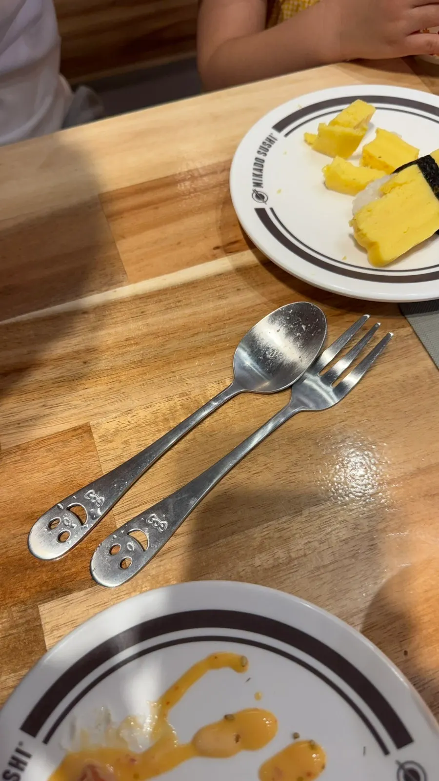 A plate of sushi set in front of the child