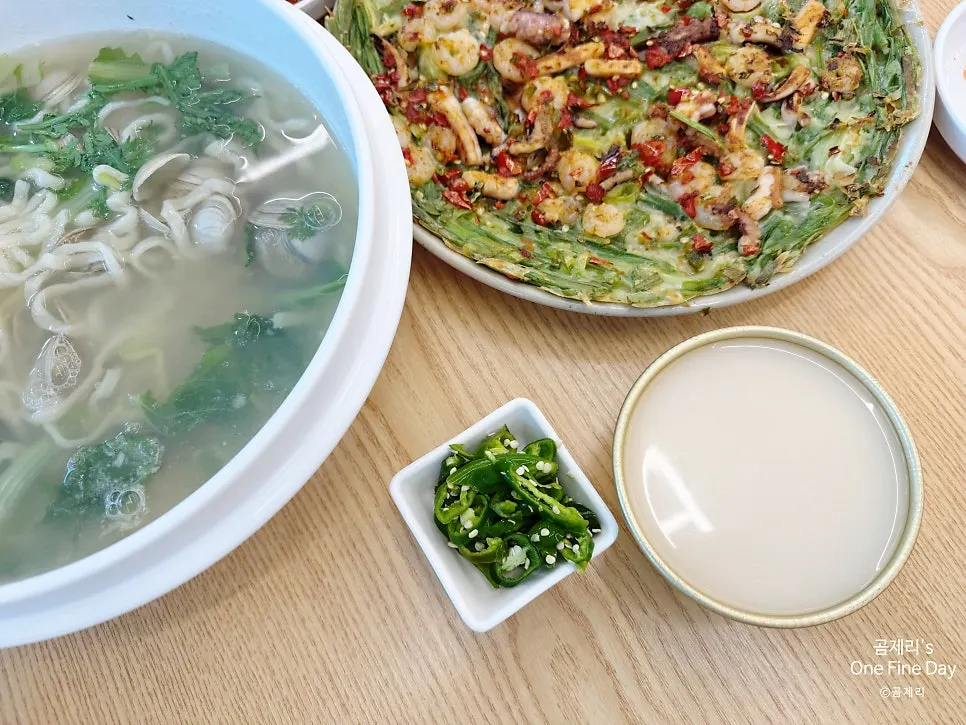 A glass of makgeolli ordered alongside the seafood pancake