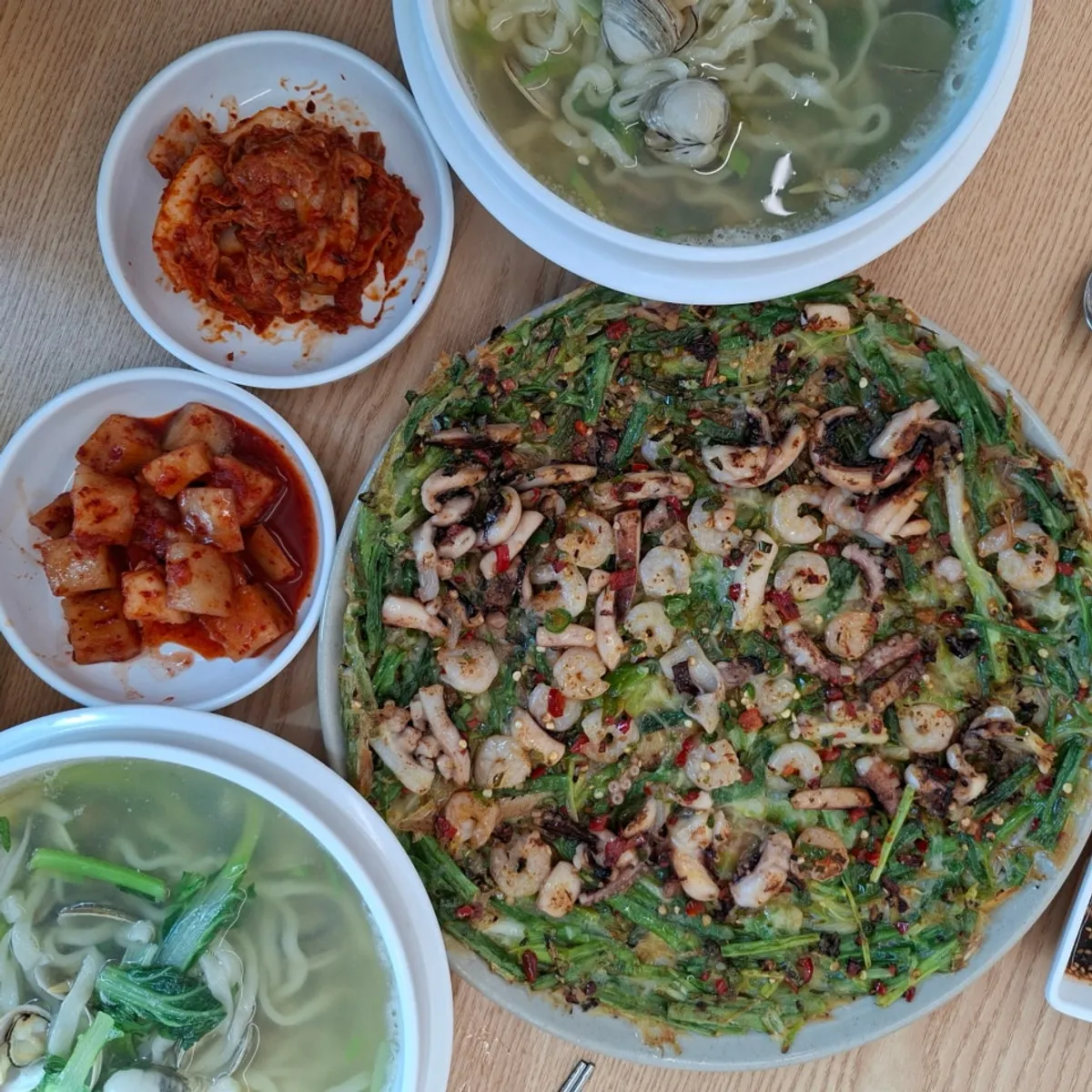 Full spread of dongjuk kalguksu and seafood pancake