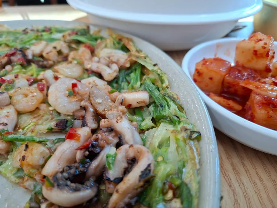 A full plate of ojaknae seafood pancake loaded with seafood