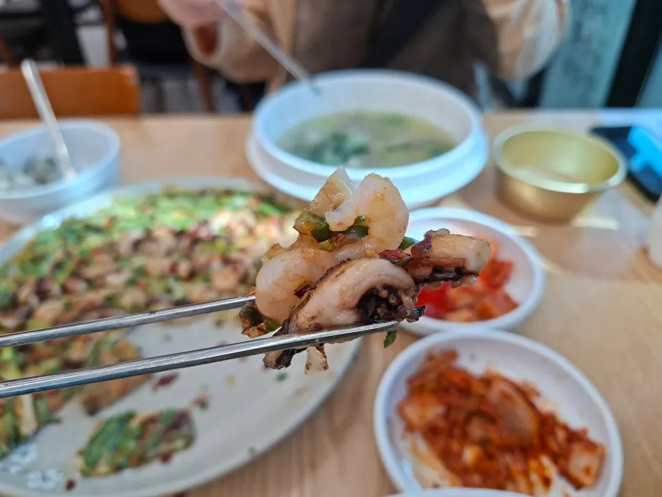 A glass of makgeolli with seafood pancake