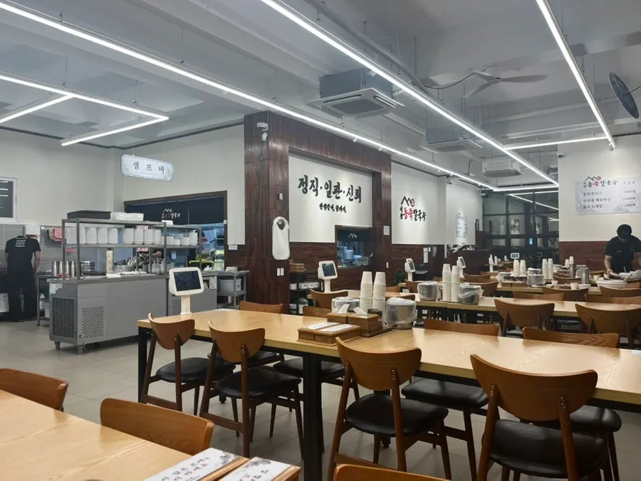 Spacious restaurant interior with white and wood tone decor