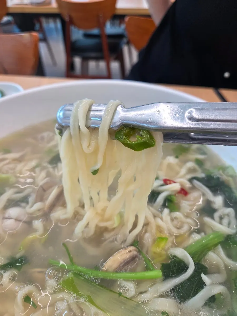 Dongjuk kalguksu bowl compared in size to a paper cup