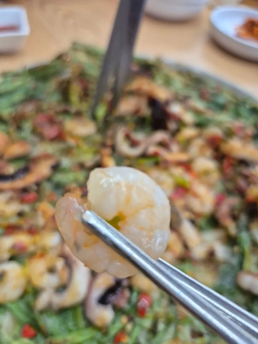 Seafood pancake topped with squid and shrimp