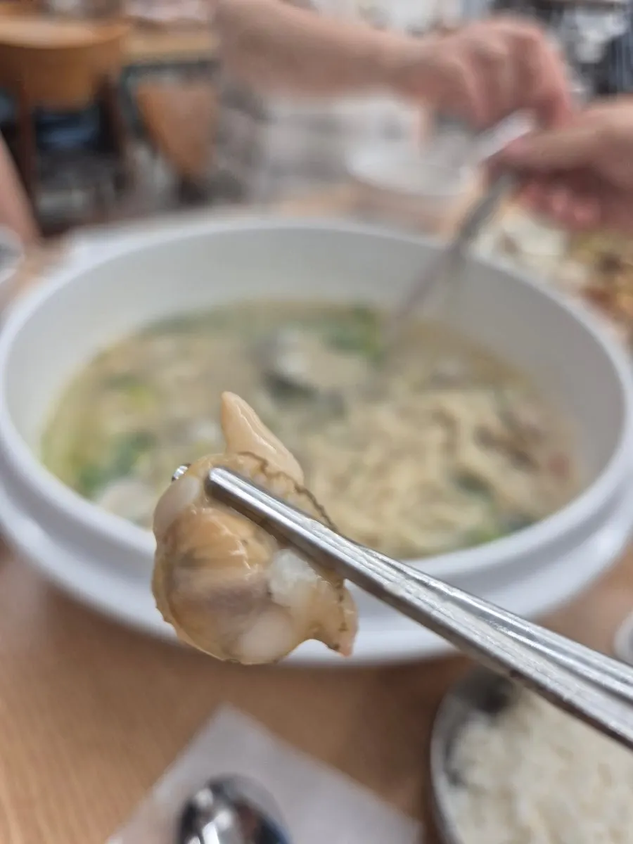 Chewy noodles lifted out of the bowl
