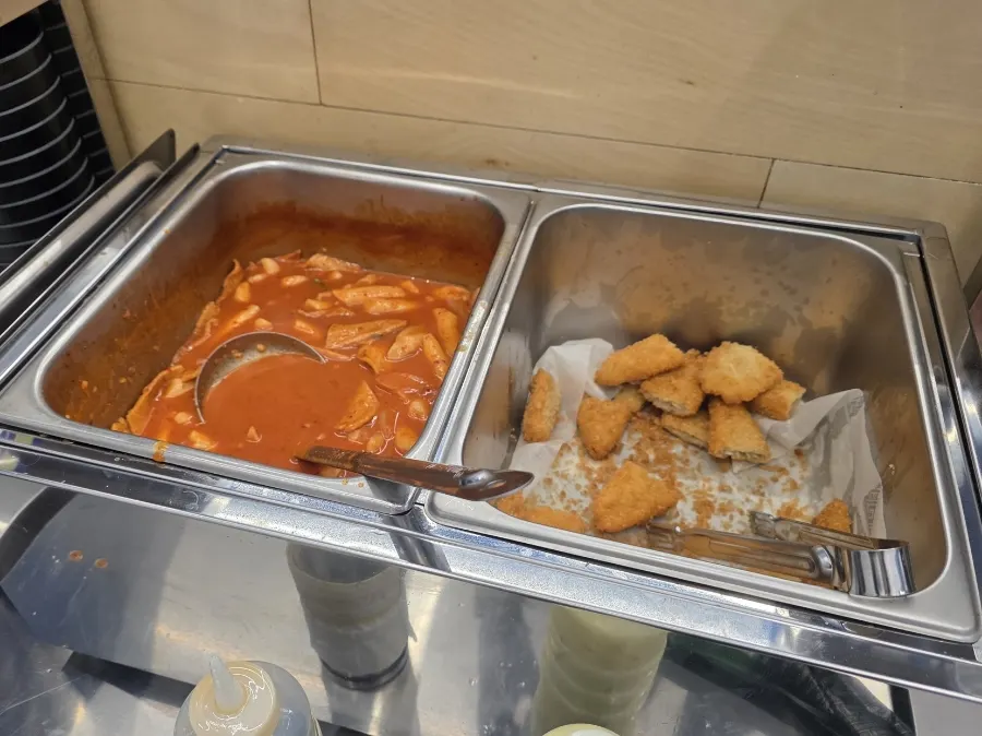 Self-serve bar with tteokbokki and pork cutlet
