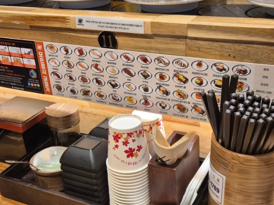Sushi and dessert plates circling the conveyor rail