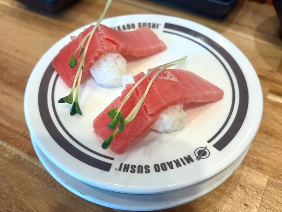 Sushi plates lined up on the table