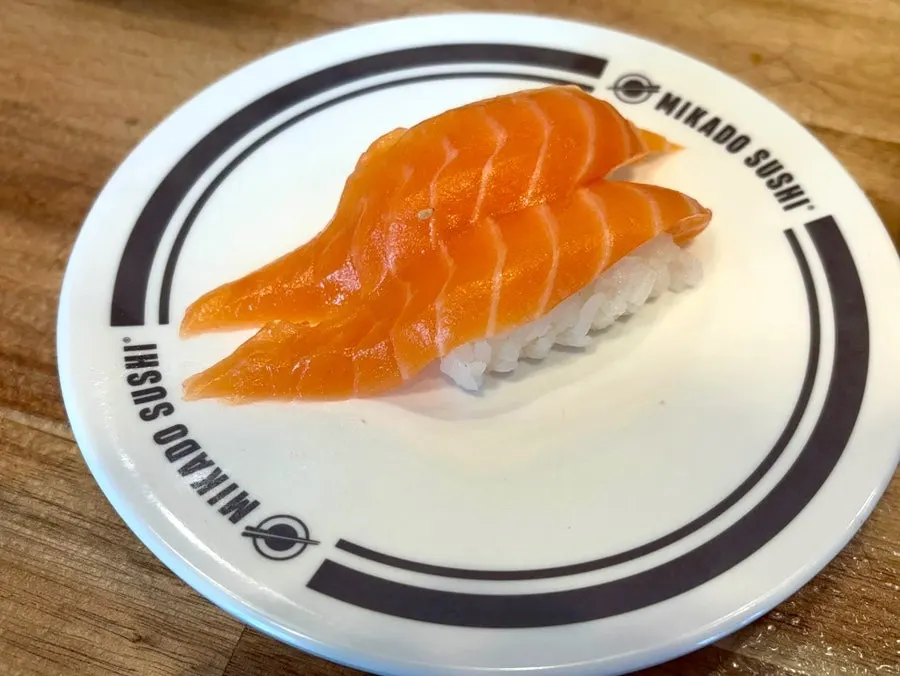 Mikado Sushi plates alongside fruit dessert