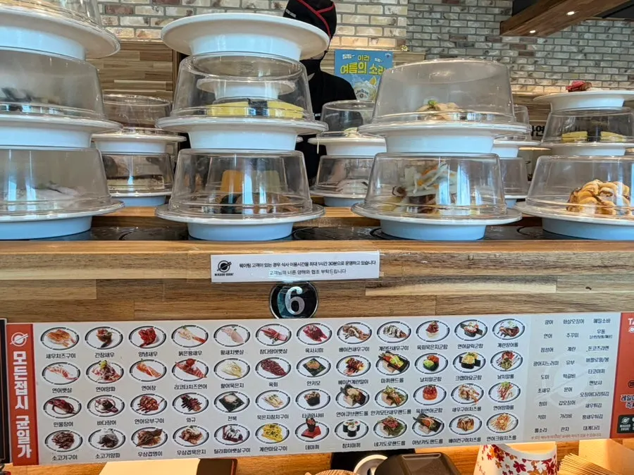 Sushi menu listed at the bar table with memo-paper ordering