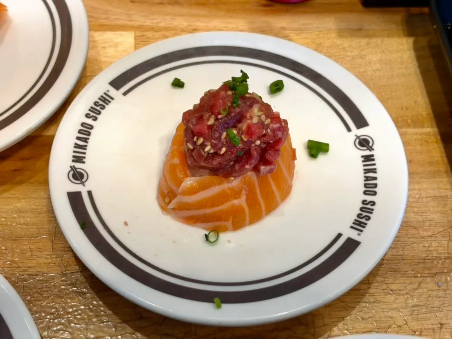 Several types of salmon sushi picked from the belt