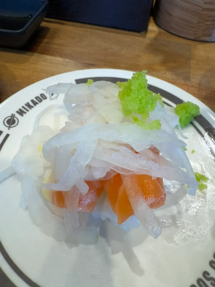 Plates of eel, beef tartare, and salmon sushi