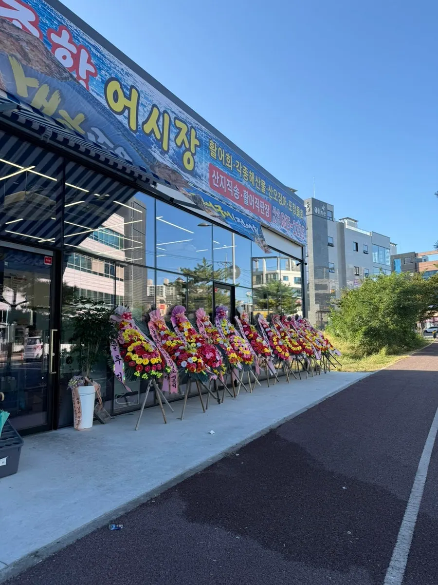Store entrance decorated with grand opening wreaths