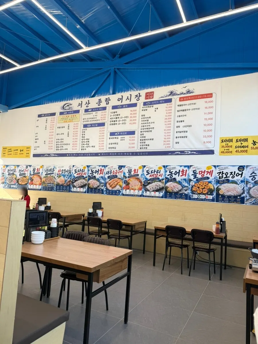 Large menu board with photos on the wall