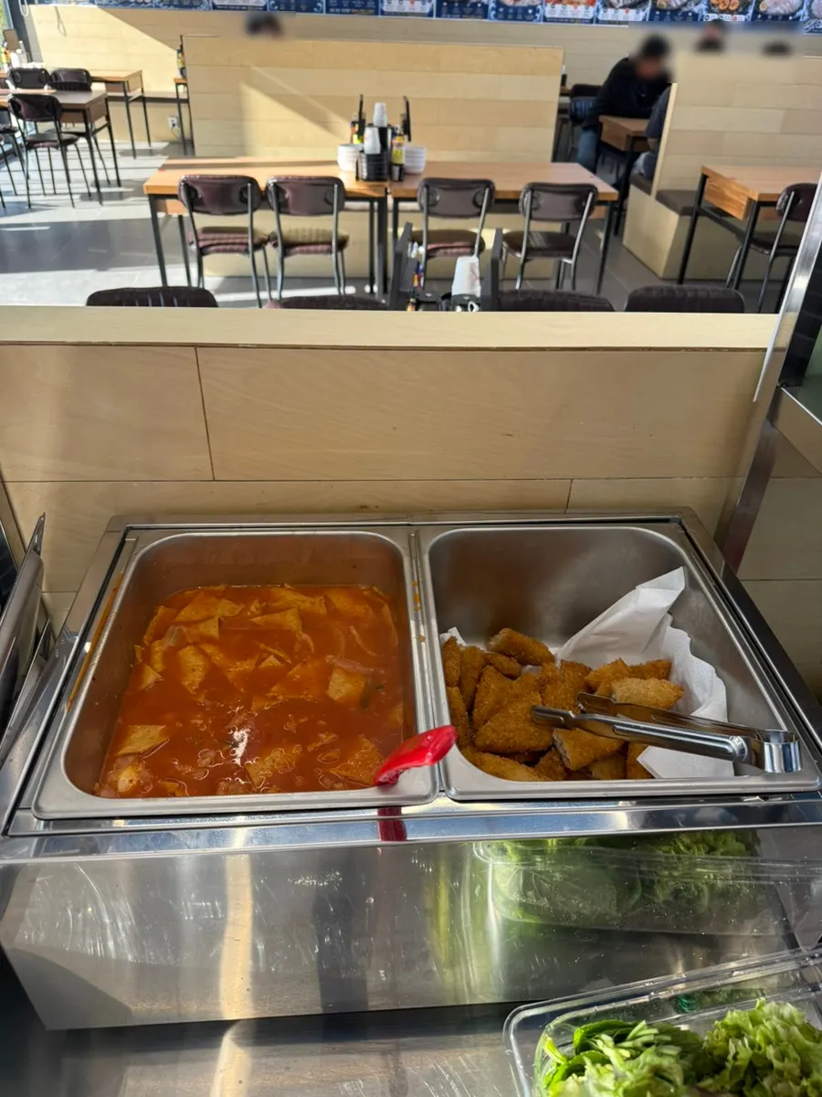 Self-serve bar with tteokbokki and fried fish cutlets