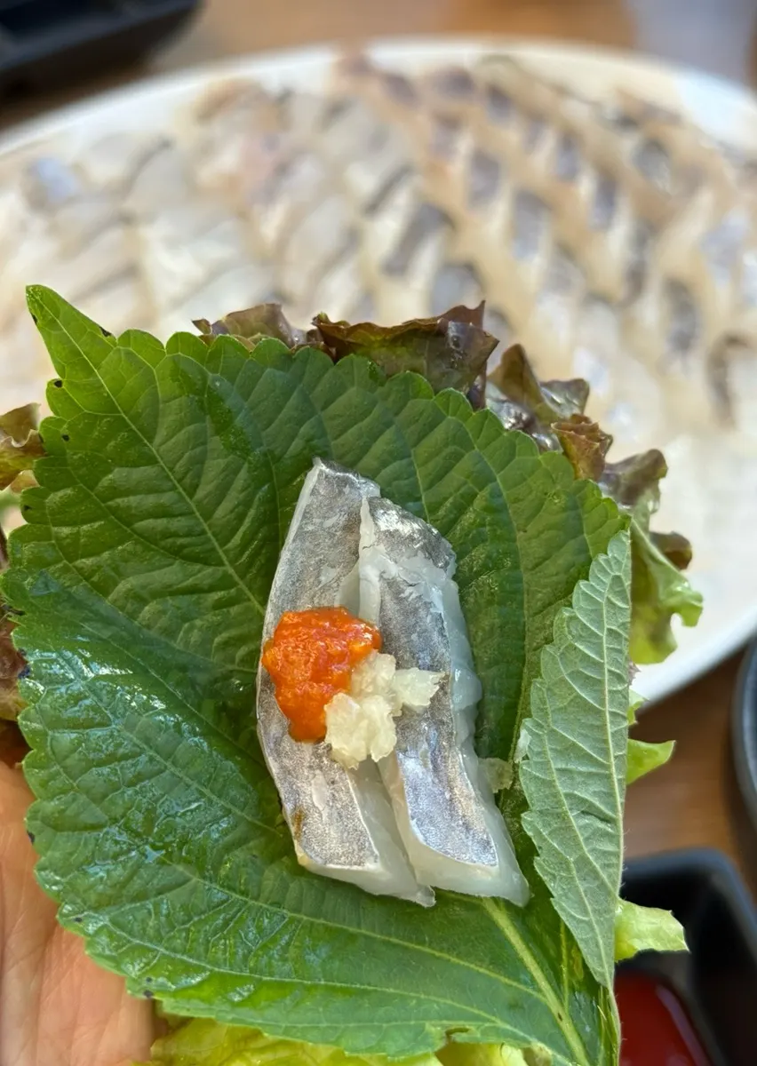 Rockfish sashimi wrapped in lettuce and perilla leaves
