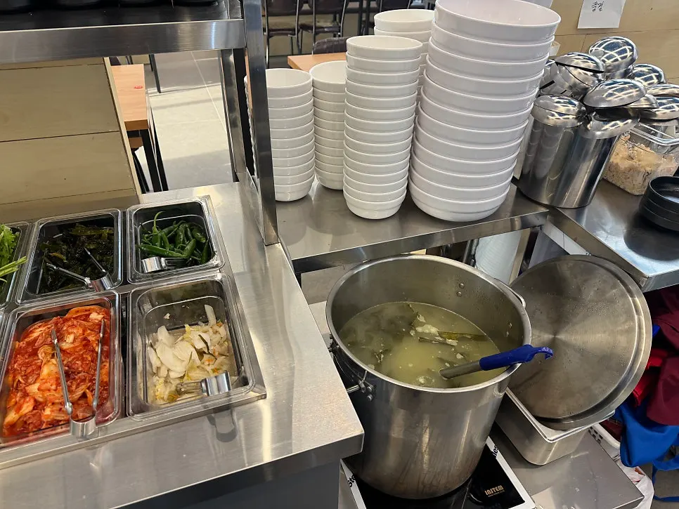 Garlic, chili, kimchi, and other side dishes at the self-serve bar