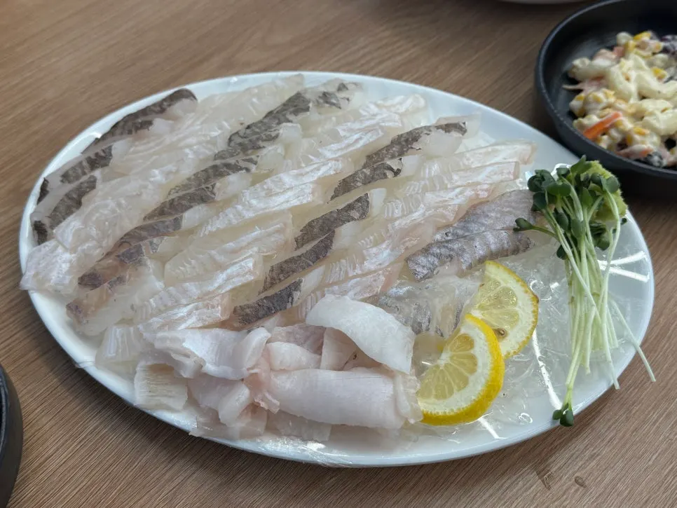 A glass of beer alongside the sashimi spread
