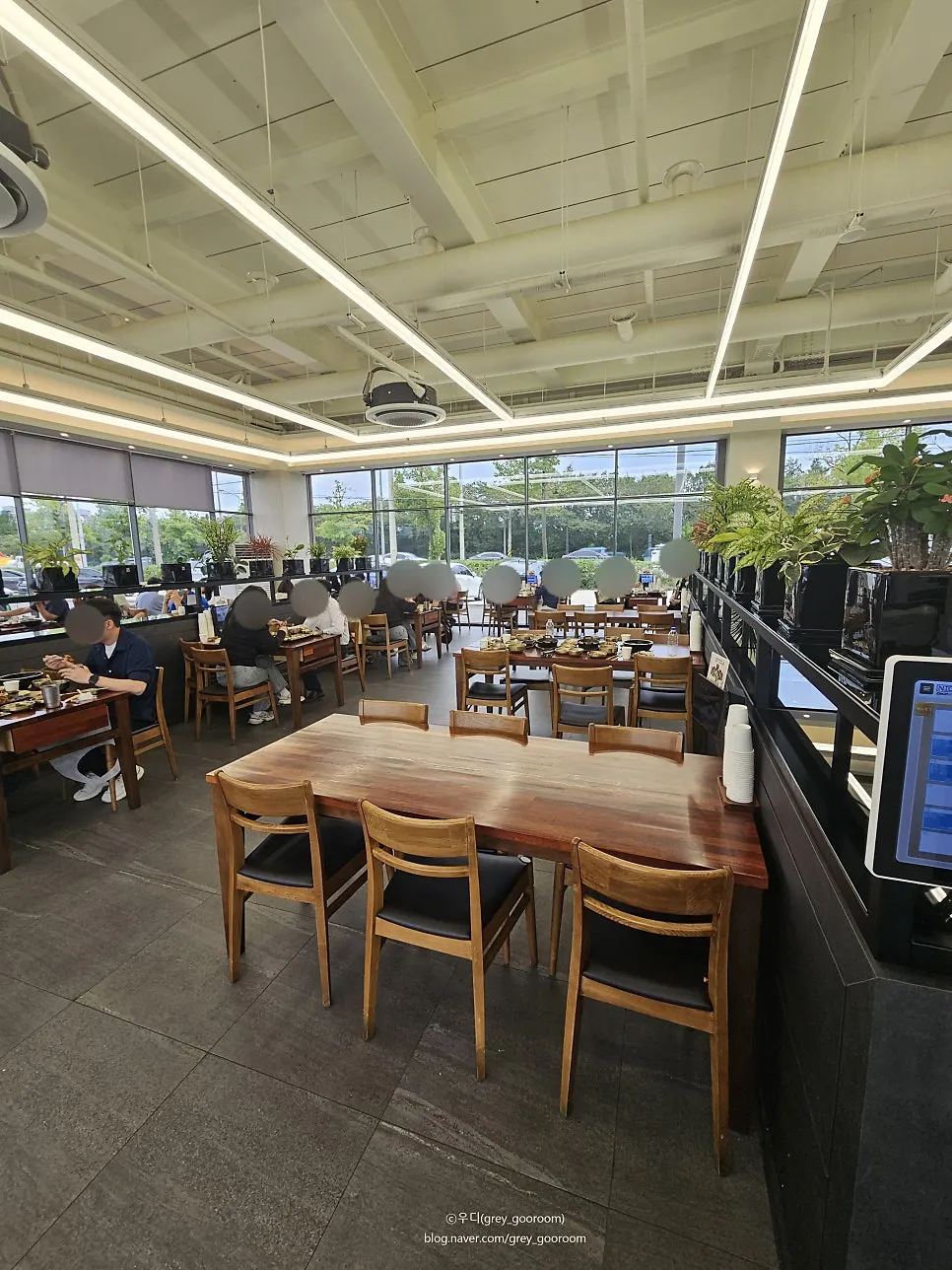 Spacious Korean restaurant interior with many tables