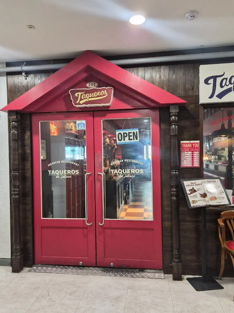 Taqueros sign visible right after stepping off the elevator