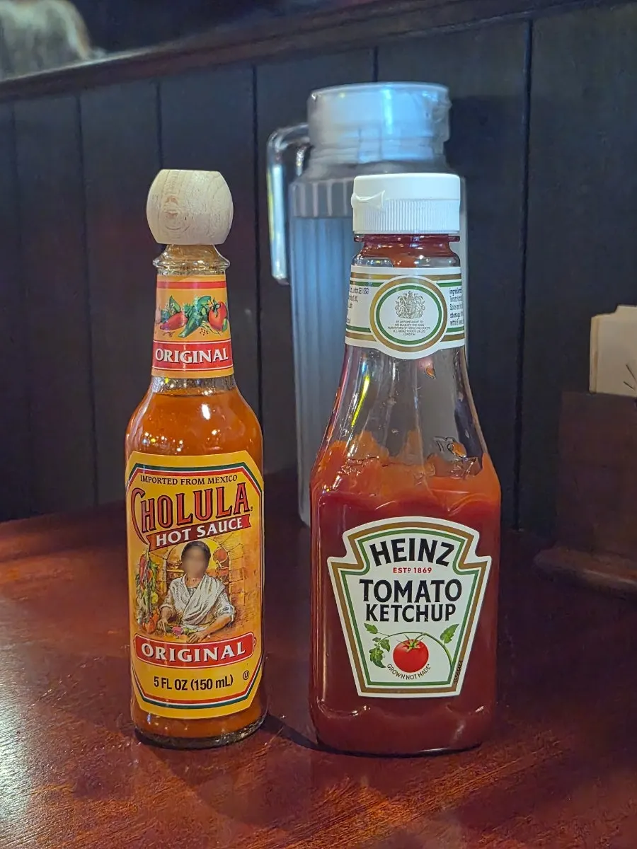 Hot sauce and ketchup on the table