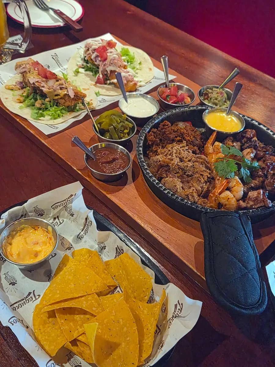 Fajita skillet topped with meat, shrimp, and vegetables