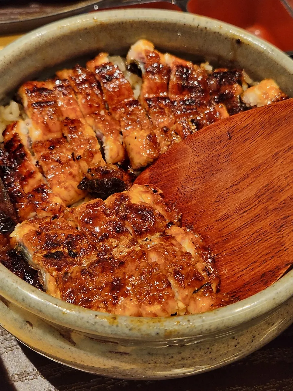 Close-up of thick eel slices laid over rice