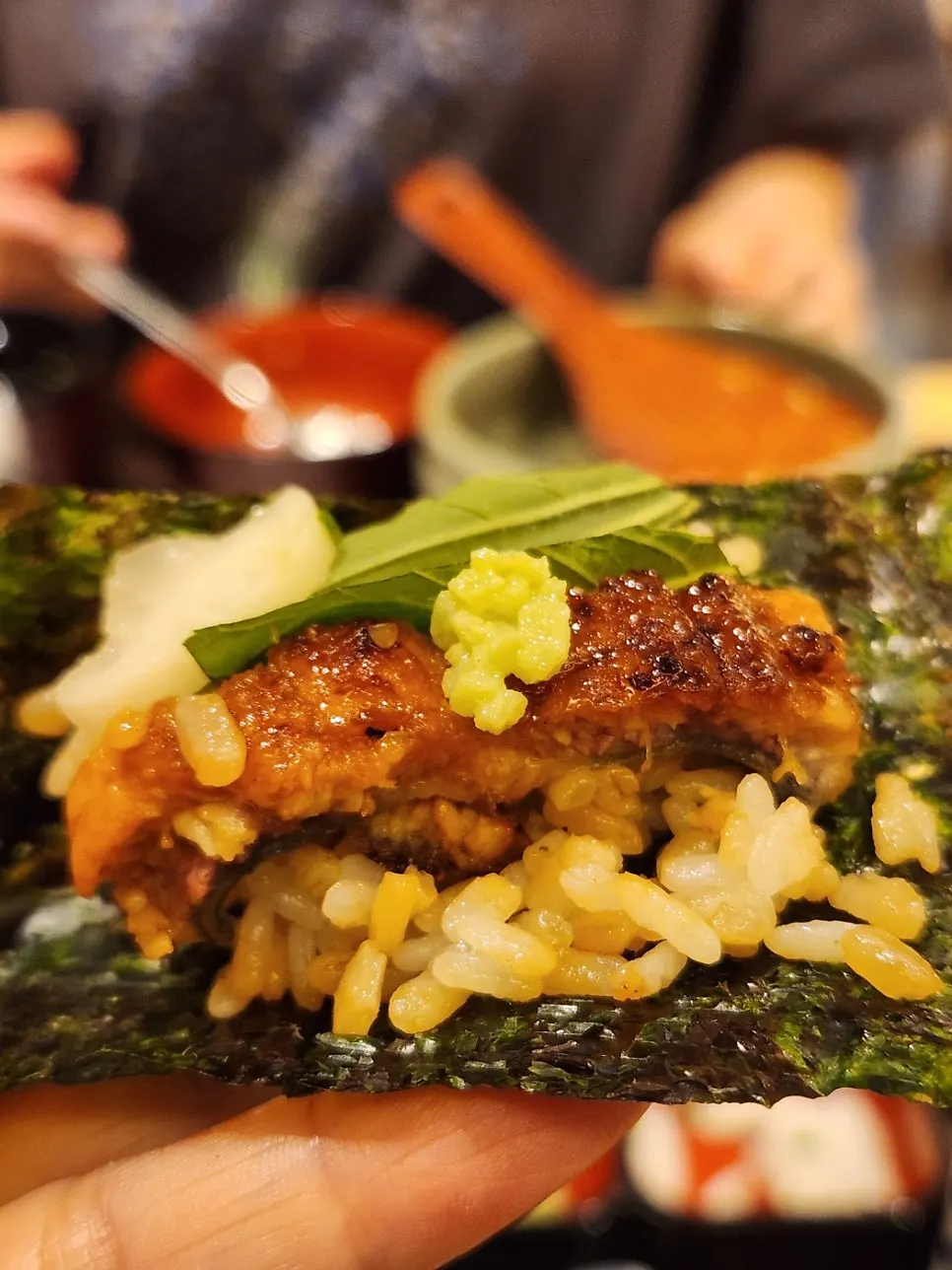 Eel and rice wrapped in seaweed with wasabi on top