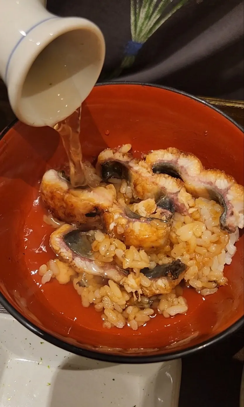 A bite of eel and rice wrapped in seaweed