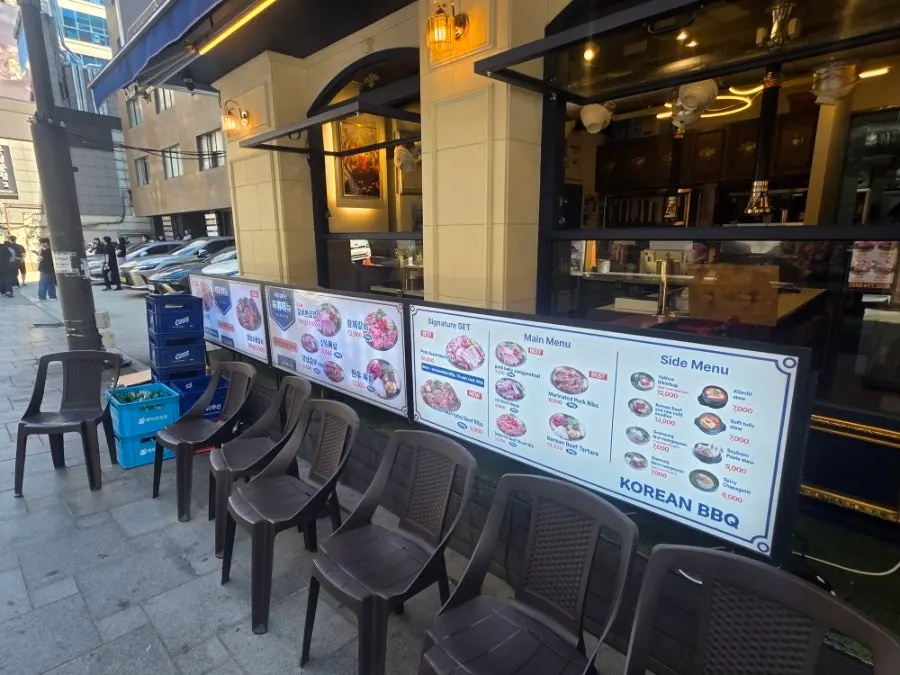 Large menu board posted outside the restaurant